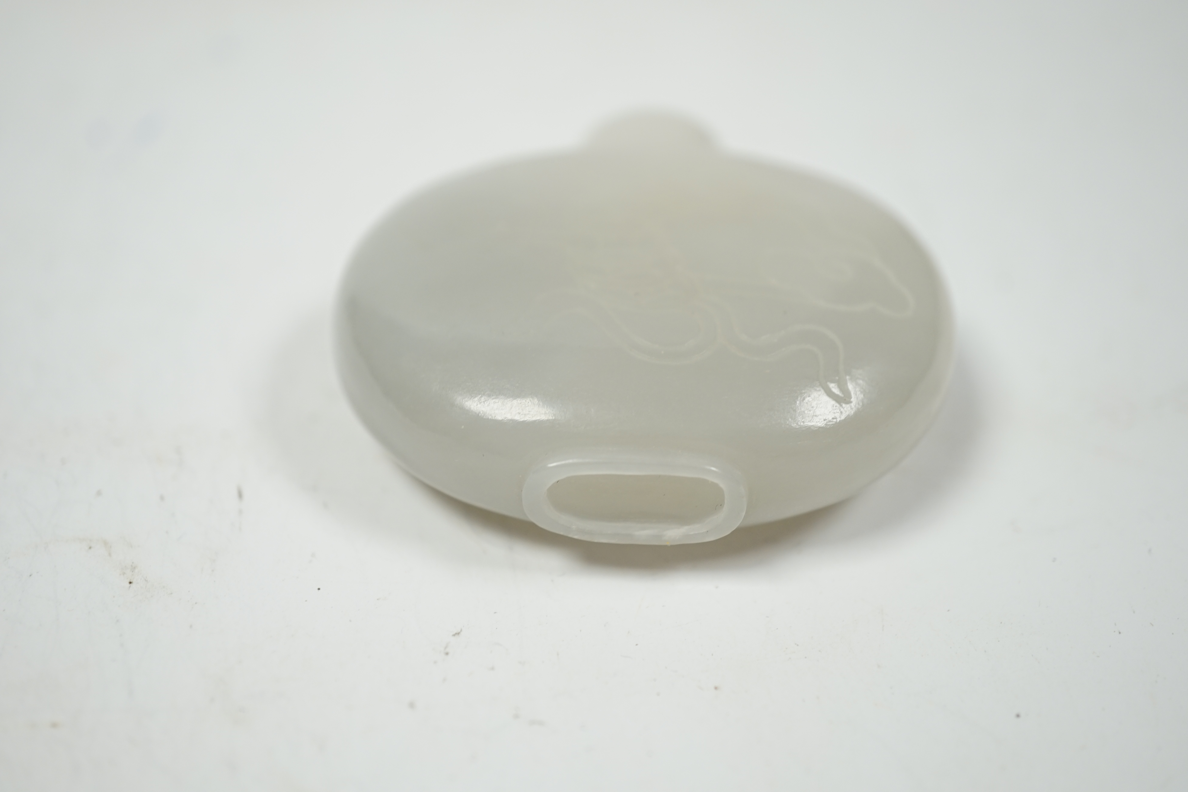 A Chinese white jade ‘chilong’ snuff bottle, 5.5cm wide